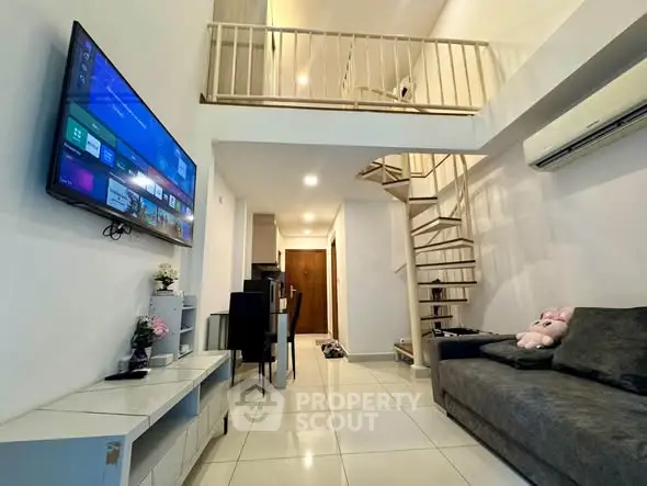 Modern loft-style living room with spiral staircase and wall-mounted TV