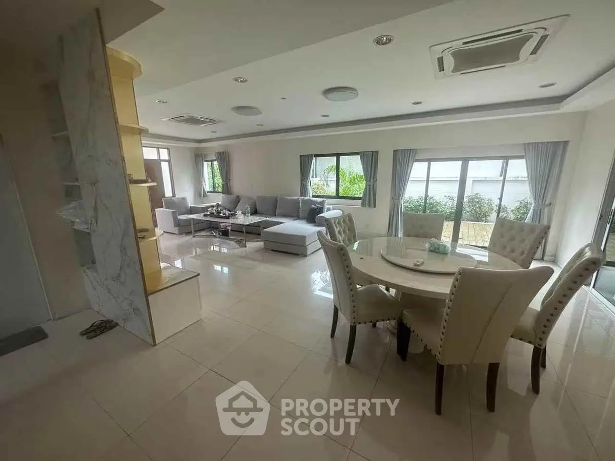 Spacious modern living room with elegant dining area and large windows