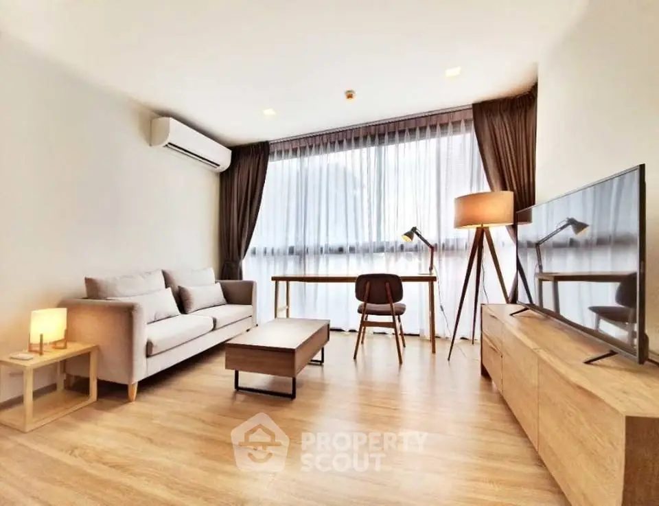 Modern living room with stylish furniture and large window for natural light.