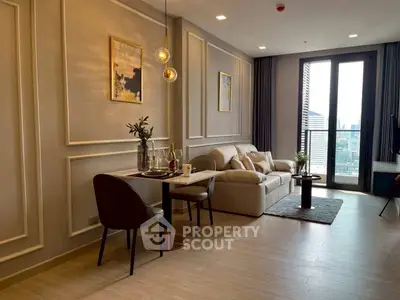 Modern living room with elegant decor and city view balcony.