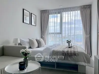 Elegant bedroom with large window and stylish decor in modern apartment