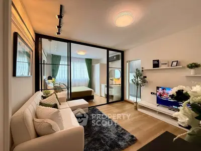 Modern living room with glass partition, cozy sofa, and stylish decor in a bright apartment.