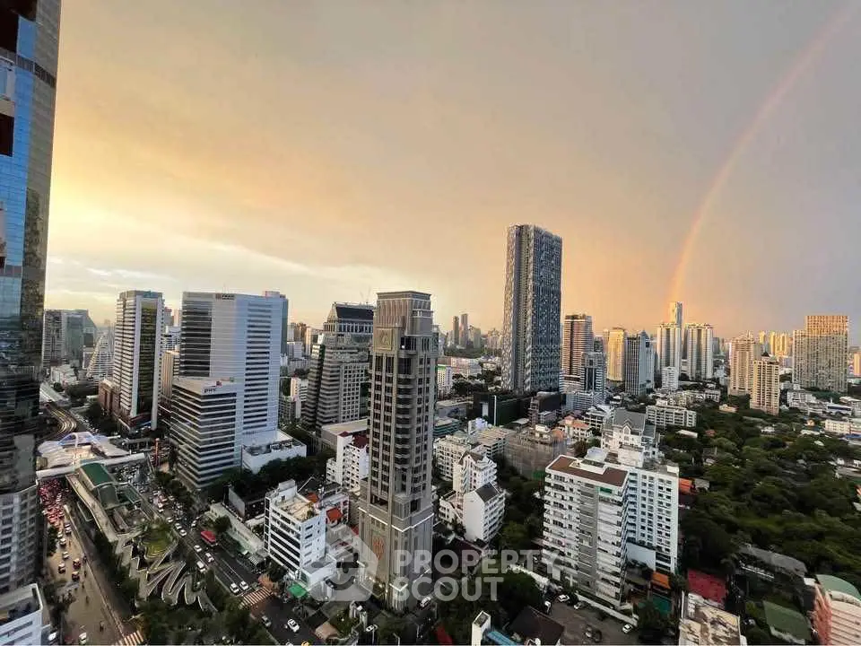 Stunning cityscape view with skyscrapers and a rainbow at sunset