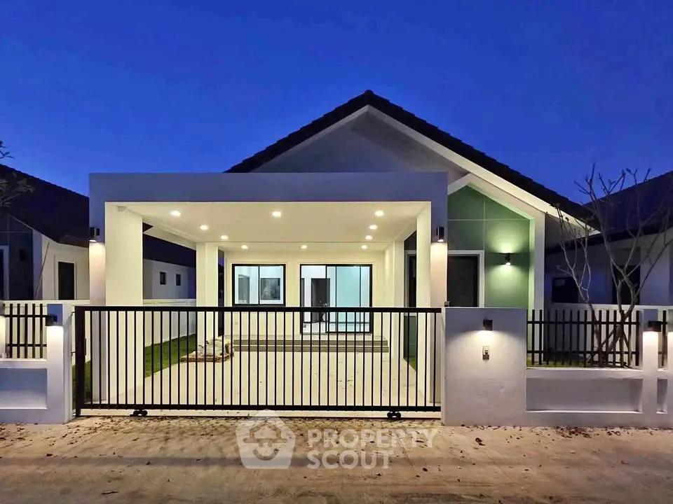 Modern single-story house with illuminated driveway and sleek design