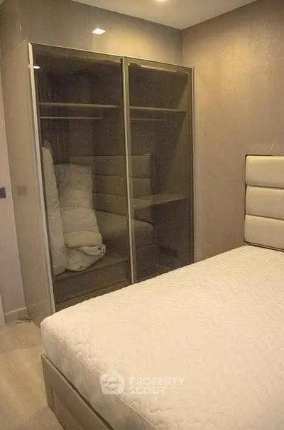 Cozy bedroom with modern wardrobe and comfortable bed in stylish apartment.