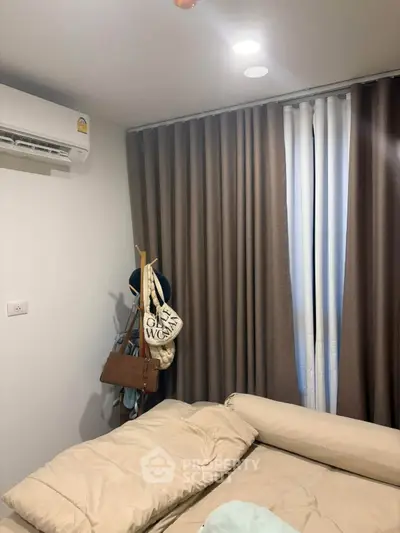 Cozy bedroom with modern air conditioning and elegant curtains