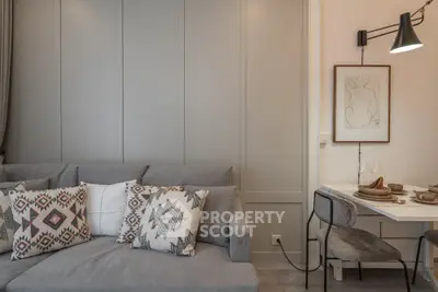 Stylish modern living room with cozy sofa and elegant dining area