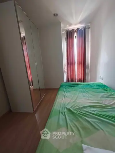 Cozy bedroom with mirrored wardrobe and natural light