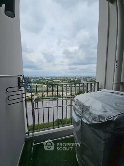 High-rise balcony with panoramic city view and laundry area.
