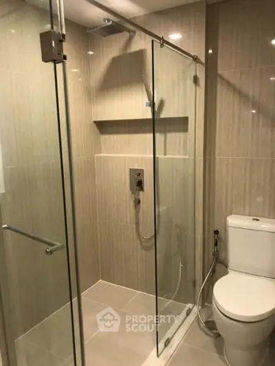 Modern bathroom with glass shower enclosure and sleek tile design