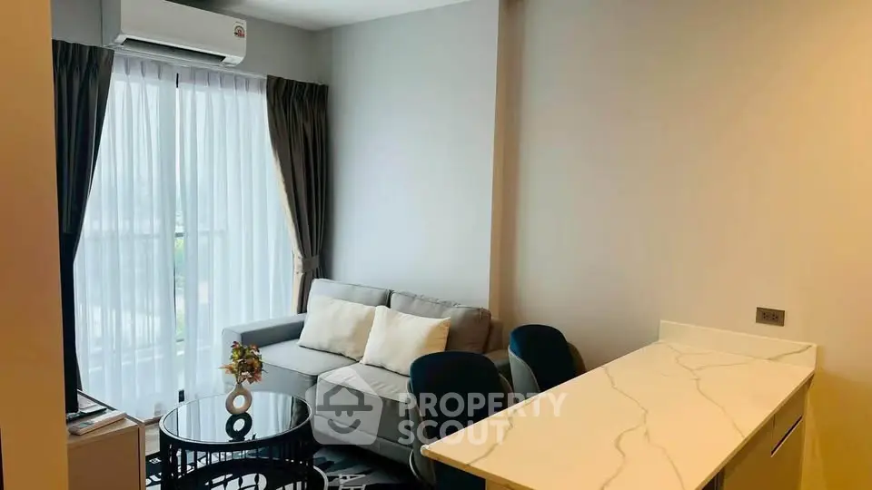 Modern living room with sleek furniture and natural light, perfect for relaxation and entertaining.