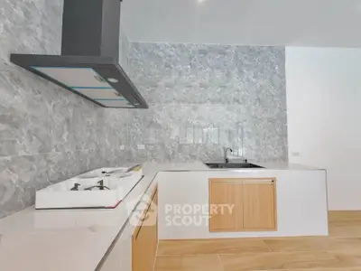 Modern kitchen with sleek marble backsplash and wooden cabinetry