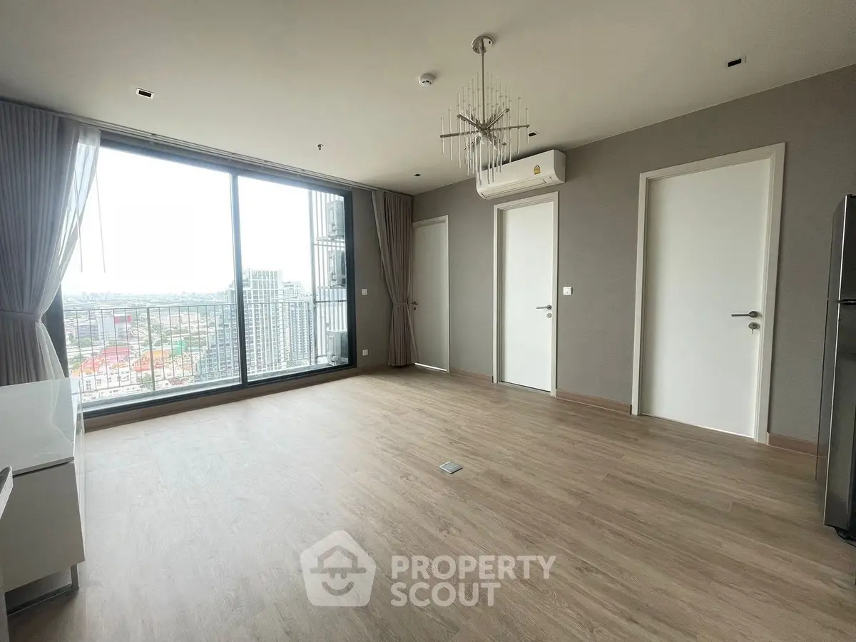 Spacious modern living room with large windows and city view