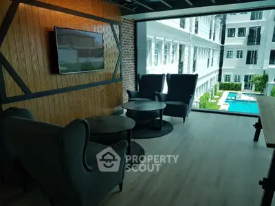Chic urban lounge area with plush seating and pool view, featuring modern design elements and a welcoming ambiance for relaxation or social gatherings.