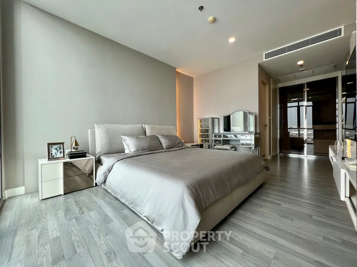 Luxurious modern bedroom with sleek design and elegant furnishings in a high-end apartment.