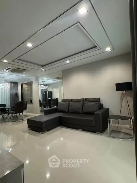 Modern living room with sleek black sofa and elegant lighting