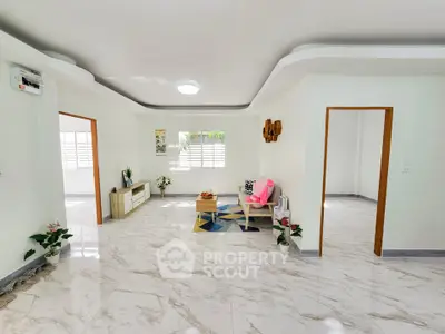 Spacious and bright living room with modern decor and marble flooring