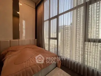 Luxurious bedroom with floor-to-ceiling windows and stunning city view.