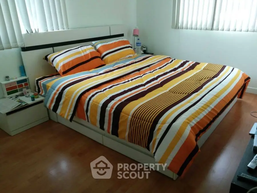 Cozy bedroom with striped bedding and natural light