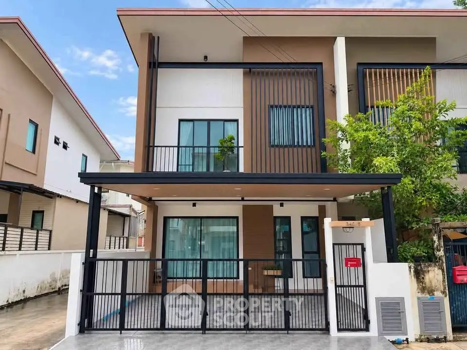 Modern two-story house with sleek design and spacious driveway in a suburban neighborhood.