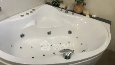 Luxurious corner bathtub with modern fixtures in elegant bathroom setting.