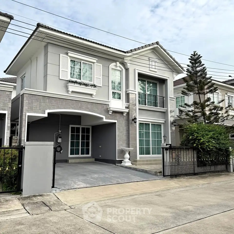Elegant two-story house with modern facade and spacious driveway in a serene neighborhood.