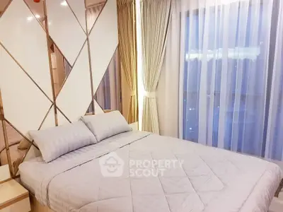 Luxurious bedroom with elegant decor and large windows offering stunning views.