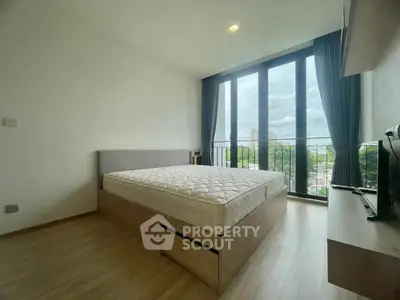Spacious bedroom with large windows and scenic view in modern apartment