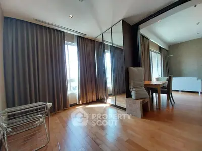 Spacious modern living room with wooden flooring and large windows