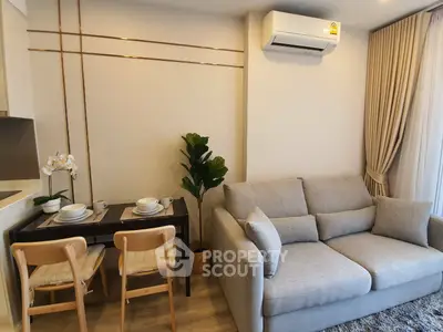 Cozy living room with modern sofa, dining table, and air conditioning in stylish apartment.