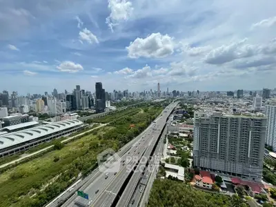 Stunning cityscape view from high-rise building overlooking highway and skyline.