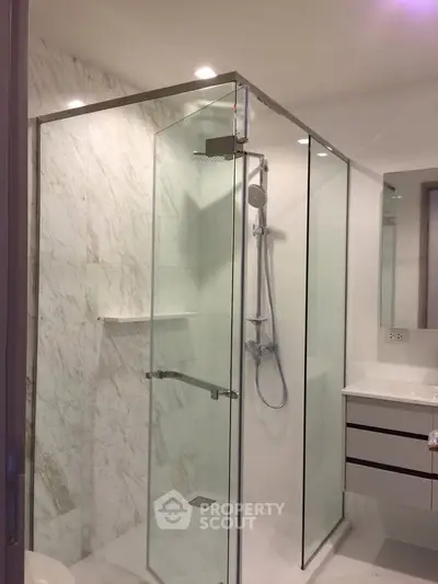 Modern bathroom with glass shower enclosure and sleek vanity