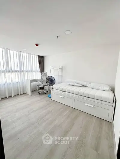Modern minimalist bedroom with sleek furniture and natural light