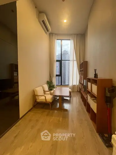 Modern living room with high ceiling and city view, featuring elegant furniture and natural light.