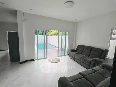 Modern living room with pool view and sleek furniture