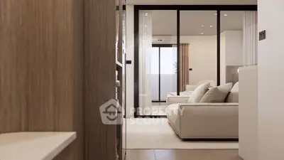 Modern living room with elegant decor and sliding glass doors leading to a balcony.