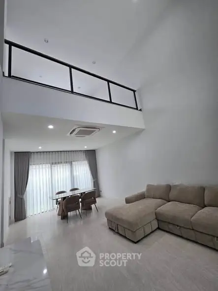 Spacious modern living room with high ceiling and elegant decor