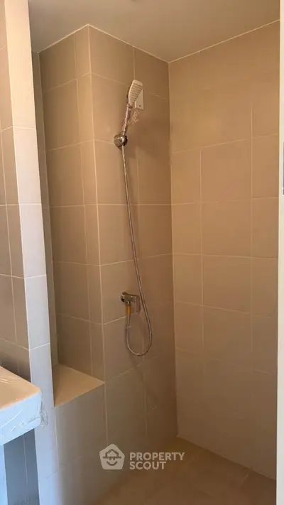 Modern bathroom with sleek shower design and neutral tiles