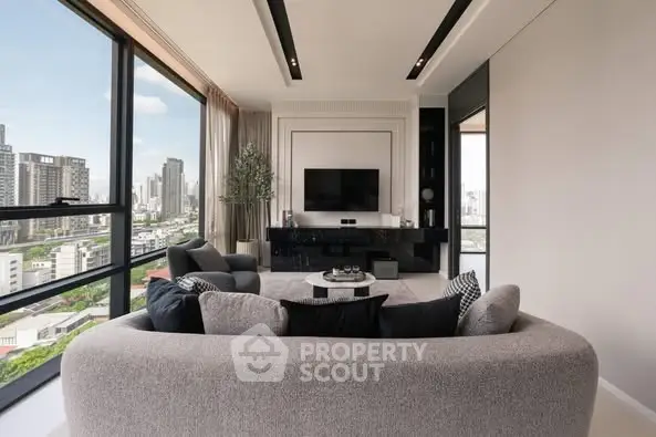 Luxurious modern living room with panoramic city views and elegant furnishings.