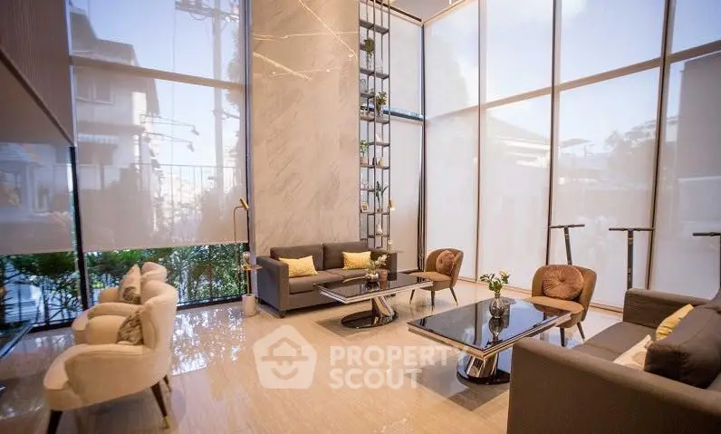 Luxurious modern living room with high ceilings and elegant decor, featuring large windows and stylish furniture.