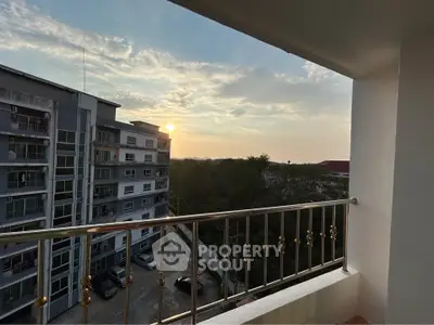 Stunning sunset view from a modern balcony overlooking the cityscape.