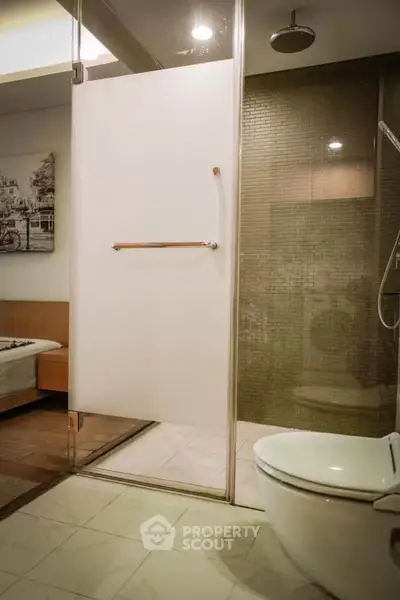 Modern bathroom with glass shower and sleek fixtures in a stylish apartment.