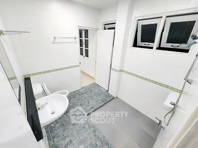 Spacious modern bathroom with dual sinks and sleek tile design
