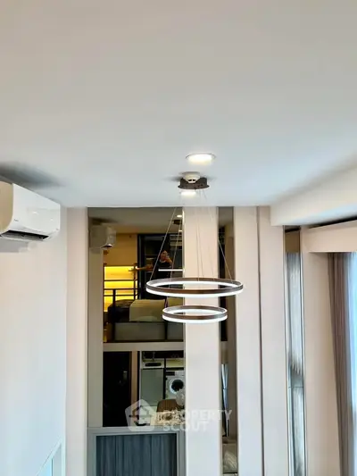 Modern interior with stylish lighting and air conditioning in a contemporary apartment setting.