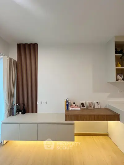 Modern minimalist living room with sleek storage and decorative accents