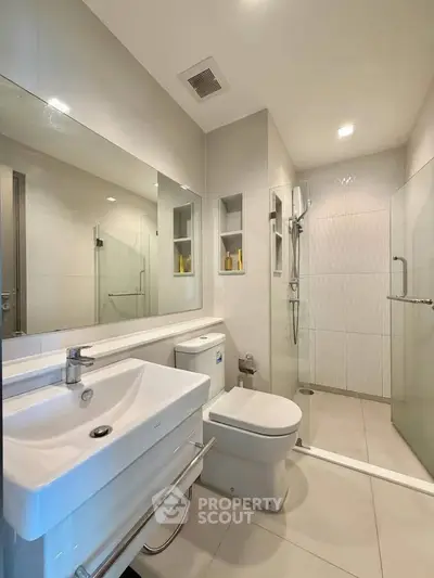 Modern bathroom with sleek fixtures and glass shower enclosure