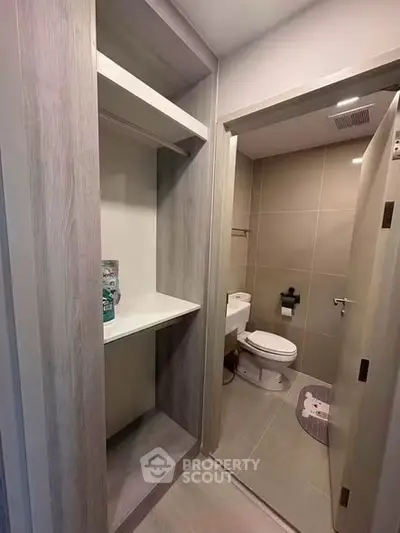 Modern bathroom with sleek design and built-in storage shelves