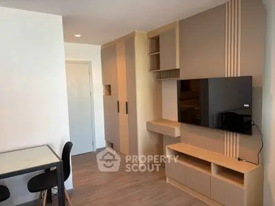 Modern living room with sleek TV unit and dining area, perfect for urban living.