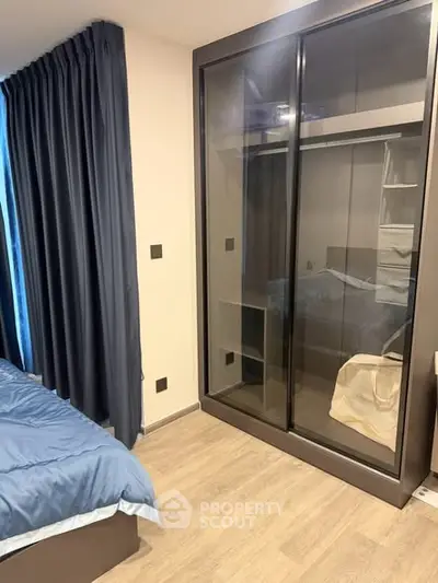 Modern bedroom with sleek wardrobe and elegant curtains