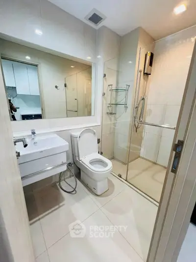 Modern bathroom with sleek fixtures and glass shower enclosure